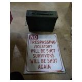 No trespassing sign and metal ammo box