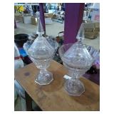 A pair of crystal compotes with lids, one lid is