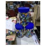 3 plastic jars of marbles.