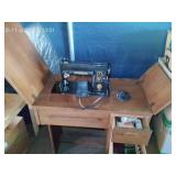 Old Black Electric Singer Sewing Machine in Table