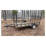 Single axle utility trailer with drop down ramp.