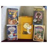 Schulz peanuts comic book & 4 vhs Disney movies.
