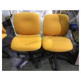 Pair of yellow gold rolling office chairs loca