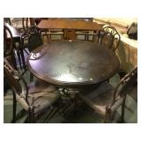 Circular wooden dining table with 4 metal chairs
