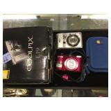 2 Nikon coolpix cameras, 1 w/ case, 1 w/ original