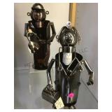 A pair of metal art wine bottle holders