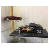 A pair of diecast cars, "PLYMOUTH PROWLER mounted