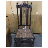 Ornately carved wooden chair w/ cane seat & back.