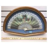 Vintage decorative fan in wood and glass shadow