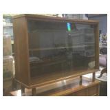 Sliding glass front wood cabinet display.