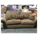 2 cushion sofa with wood trim sides and pillows -