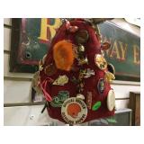 Cloth hat covered with assorted pins and buttons