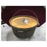 Cast iron covered Dutch oven, footed, 13 in D.,