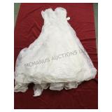 A wedding gown and dress. The first gown is a