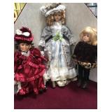 7 porcelain dolls on 5 stands
