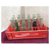 Tray of coke bottles & 1  seven-up bottle
Local