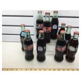 Coke collectible Bottles,  10 full bottles, most