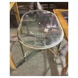 Metal oval glass top coffee table.       
Local