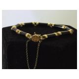 14 k gold Asian style bracelet w/ dark gemstone