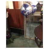 Outdoor glass gazing ball on a wire stand,