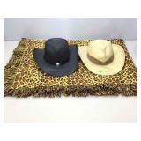 2 straw cowboy hats and leopard throw.