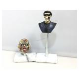 2 character mini busts on stands.