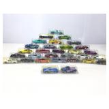 Assorted die cast cars in plastic cases.