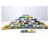 Assorted die cast cars in plastic cases.