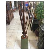 Metal vase with decorative sticks, approx 5 ft