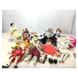 Assortment of collectible dolls. Some on stands.