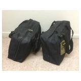 A pair of black bags full of personal care items,