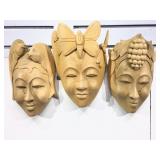 Three carved wood face masks.