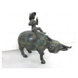 Metal child on water buffalo.