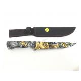 Skull and dragon pattern knife with sheath.