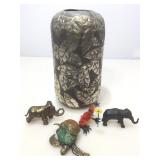 Metal vase with animal figures.