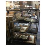Rack of assorted framed prints