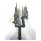 Pair of ornate metal sheathed knives. Larger has