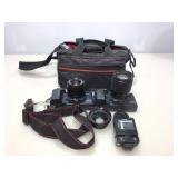 Ricoh camera and accessories in carry bag.