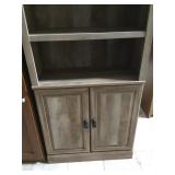 Gray solid wood bookshelf with doors