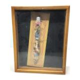 Dragon knife on stand in shadow box.