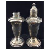 Sterling weighted shakers. One is missing the cap