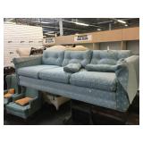 Blue couch w/pattern design and matching pillows,