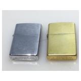 Pair of Zippo flip top lighters.