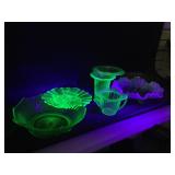 Collection of green vaseline glass pieces.