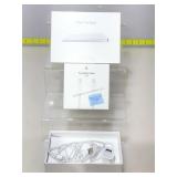 Apple cords, track pad and more in boxes.