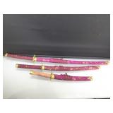 3 piece decorative sword set. Some fabric missing