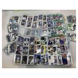 Mixed sports cards in pages and cases