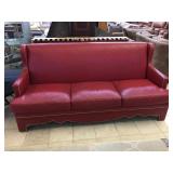 A Rudin red couch w/studded accents from high end