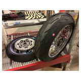 Two tires on rims. Assorted.
