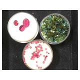 3- ramekins of gemstones, 2- rubies & 1 green